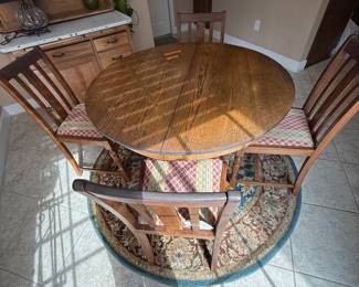 Oak round dining table and four chairs