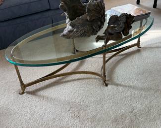 Vintage Italian Hollywood Regency style brass and glass oval coffee table with hoof feet
