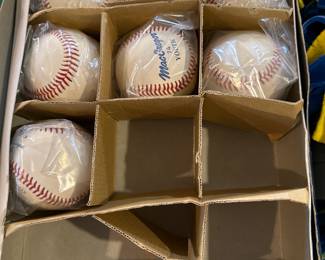 several books old books on baseball
One very old baseball, then a box  with baseballs