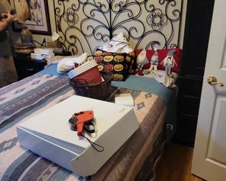 Metal bed frame with with ornate scrollwork headboard. 