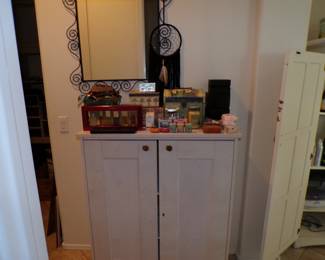 Small cabinet, Various candles. Yankee Candle Co. Perfumes and other bathroom decor.