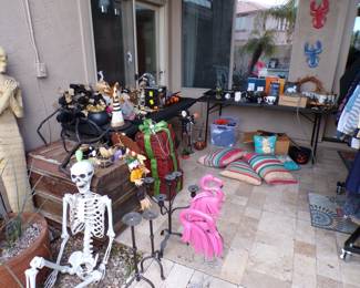 various Halloween items, steamer trunk, metal flamingos.