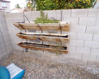 3-tier wall haning planters with elephant bush plants.