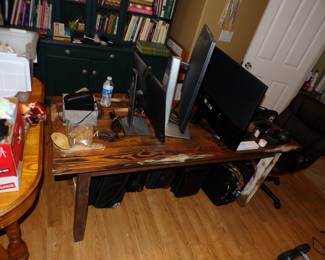 Wooden Table and computer monitors.