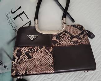 Prada handbag with faux snakeskin and leather panels.