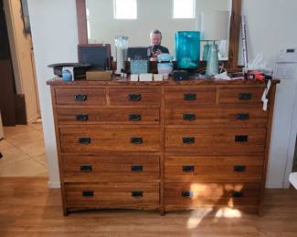 Solid wood dresser by Tree Crowns Furniture featuring multiple drawers with visible dovetail construction, indicating quality craftsmanship and durability. It is an an American Mission style Amish inspired piece. Mirror sold separately.