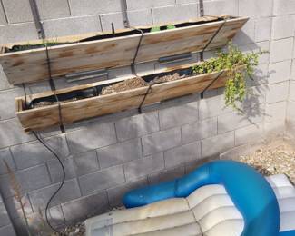 Two oversized weathered wood hanging wall planters with drip system and live plants. Perfect Southwest patio decor – great for herbs, succulents, or trailing vines.

