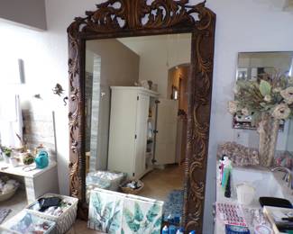 Huge standing mirror. At least 8 feet tall.