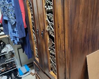 Solid wood  armoire with ornate detailing. 