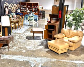 Vintage Warehouse Interior with Mixed-Era Furniture and Mid-Century Seating