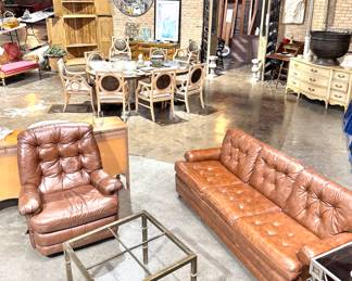 Curated Vintage Interior with Leather Seating, Antique Dining Chairs, and Rustic Decor