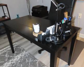 Black office desk/table and leather chair.