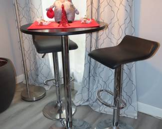 bar height bistro set with swivel and adjustable height stools.