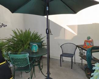 Patio table, umbrella, chairs, cart and ferns.
