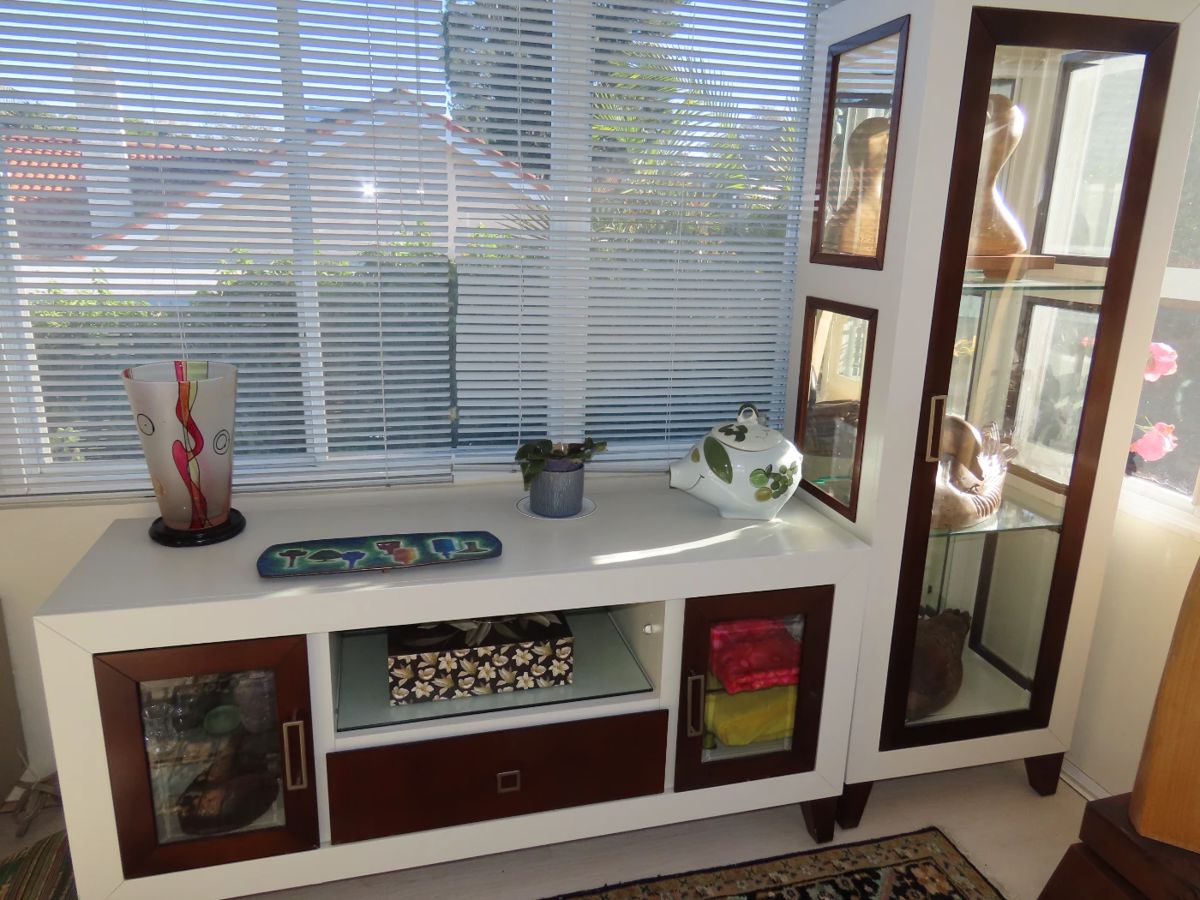 Two piece modern curio and media center.