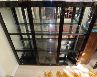 Black glass display cabinet with no doors.