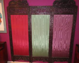Three panelled screen, carved wood frame and fabric centers.