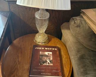 lamp, John Wayne book, oval side table