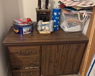 Sewing cabinet full of items. Everything goes in on and beside it.