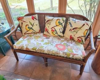 Rattan settee with bird pillows