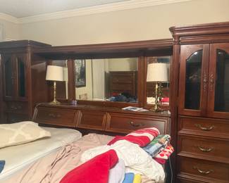 Complete solid-wood bedroom set originally purchased from The Oak Mill in Addison, a high-end furniture retailer. This is a matching, traditional suite from the early 2000s (not big-box furniture) with rich dark wood finish and heavy, well-built construction. Includes dresser with mirror, multiple chests (gentleman’s and lingerie), chest of drawers, and coordinating headboard/wall units. Quality craftsmanship throughout, sturdy and substantial pieces that have held up well. Originally over $6,600 new.