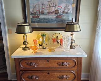 American Late 19th century commode with marble top & applied handled. Collection of Carnevale Glass, Depression Glass & a pair of 1970s "antiqued tone" library lamps with metal shades.