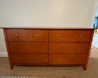 P82 - $85. 6 Drawer Dresser. Pressed Wood. All drawer slide - missing 1 knob. Top has some minor surface scratches. Measures 63.5" x 17.5" x 33.5" tall. 