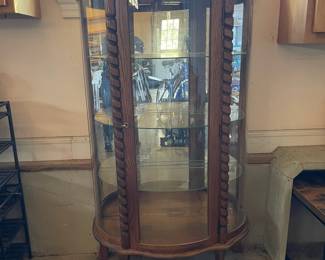 R276 - $95. Oak Bow Front Cabinet. Measures 34" wide x 15.5" deep x 58" tall. Top Curved Trim on the right side is cracked. All Glass is intact! Key is included. It does wiggle a little and needs some work. 