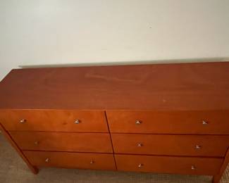 P82 - $85. 6 Drawer Dresser. Pressed Wood. All drawer slide - missing 1 knob. Top has some minor surface scratches. Measures 63.5" x 17.5" x 33.5" tall. 