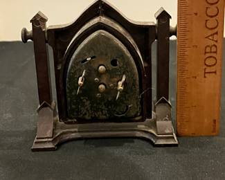P54 - $40. New Haven Artlarm Clock - Gothic Style. I believe the case is Bakelite. One chip on back of pillar - right side. Measures 5" wide x 4.5" tall. Clock does NOT work currently. 
