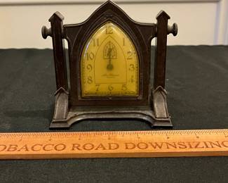 P54 - $40. New Haven Artlarm Clock - Gothic Style. I believe the case is Bakelite. One chip on back of pillar - right side. Measures 5" wide x 4.5" tall. Clock does NOT work currently. 