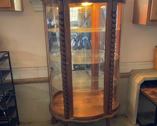 R276 - $95. Oak Bow Front Cabinet. Measures 34" wide x 15.5" deep x 58" tall. Top Curved Trim on the right side is cracked. All Glass is intact! Key is included. It does wiggle a little and needs some work. 