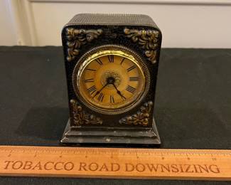 R194 - $25. Small Antique Clock - Made in Germany. Front has been pushed in a needs a little work. 