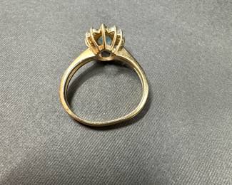 A6 - $340. 14kt Gold Ring with light blue stone and diamond surrounds. Ring is bent but about a size 8. 