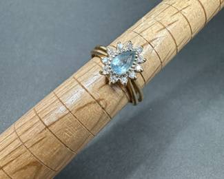 A6 - $340. 14kt Gold Ring with light blue stone and diamond surrounds. Ring is bent but about a size 8. 