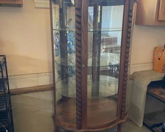 R276 - $95. Oak Bow Front Cabinet. Measures 34" wide x 15.5" deep x 58" tall. Top Curved Trim on the right side is cracked. All Glass is intact! Key is included. It does wiggle a little and needs some work. 