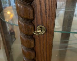 R276 - $95. Oak Bow Front Cabinet. Measures 34" wide x 15.5" deep x 58" tall. Top Curved Trim on the right side is cracked. All Glass is intact! Key is included. It does wiggle a little and needs some work. 