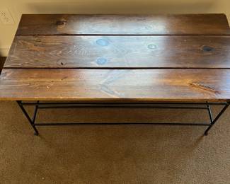 P98 - $40. Wooden Top Coffee table with Iron Base. Measures 47" wide x 23.5" x 18" tall. Would benefit from some reinforcements under the wood. 