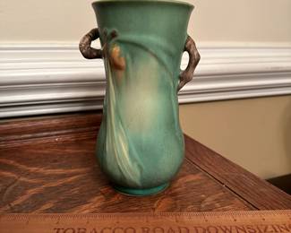 R201 -  $85. Roseville 841-7" 2 Handled Vase with Pinecones - Green. Measures 4" wide x 7" tall. 