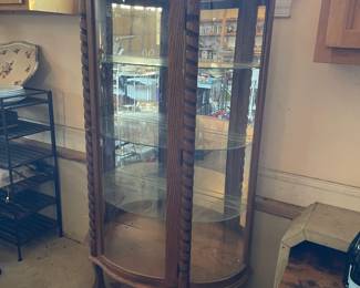 R276 - $95. Oak Bow Front Cabinet. Measures 34" wide x 15.5" deep x 58" tall. Top Curved Trim on the right side is cracked. All Glass is intact! Key is included. It does wiggle a little and needs some work. 