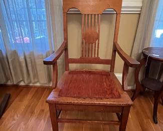 R134 - $50. Single Chair Solid Wood. Antique or very vintage. The chair was once caned and later a solid piece was placed on the top. Measures 22" wide x 17.25" x 42.5" tall. 