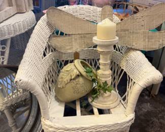 wicker chair, pot, large wooden candlestick, dragon fly art