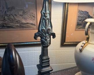 Decorative cast iron spear finial  with intricate scrollwork below the point 