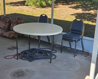 48-in round plastic patio table folds in half and four metal stacking chairs $100.00 