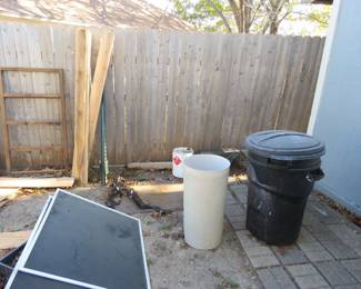 Trash cans and lumber, more in shed