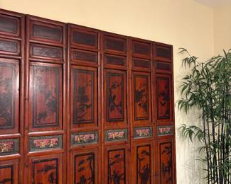 Antique Chinese wooden screen with six panels.  It is currently mounted on a wall.  Hinges are still in place.