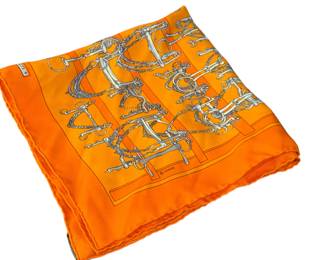 Elegant Hermes Paris 'Mors et Filets' scarf crafted in 100% silk. Features an orange background with intricate horse bit and bridle design. The scarf measures approximately standard size for Hermes silk scarves and is made in France. Signature branding appears within the artwork.
Features:
Authentic Hermes Paris design - 'Mors et Filets'
100% silk
Made in France
Classic orange with detailed equestrian motifs