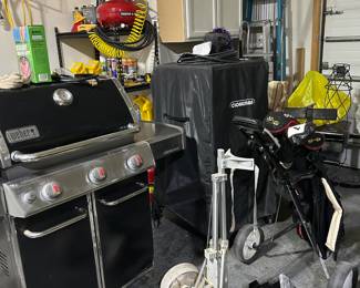 Large Weber grill alongside a smoker 