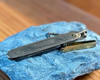 This lot features a vintage N.C. Co. two-blade pocket knife, potentially a fruit or gentleman’s knife, with a gold-filled engraved handle. 

