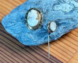 This lot features a pair of cameos – one is a brooch and the other is a stick pin. 

